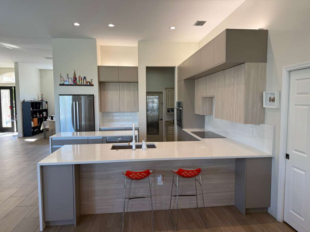 Lakewood Ranch kitchen — Two-Tone European cabinets with Calacatta quartz waterfall island